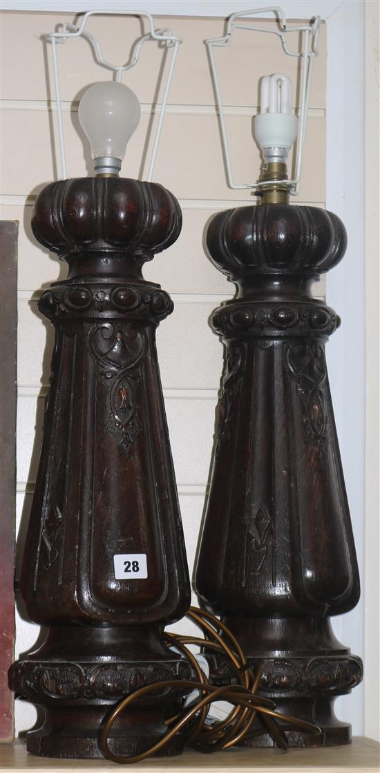 A pair of carved oak table lamp bases